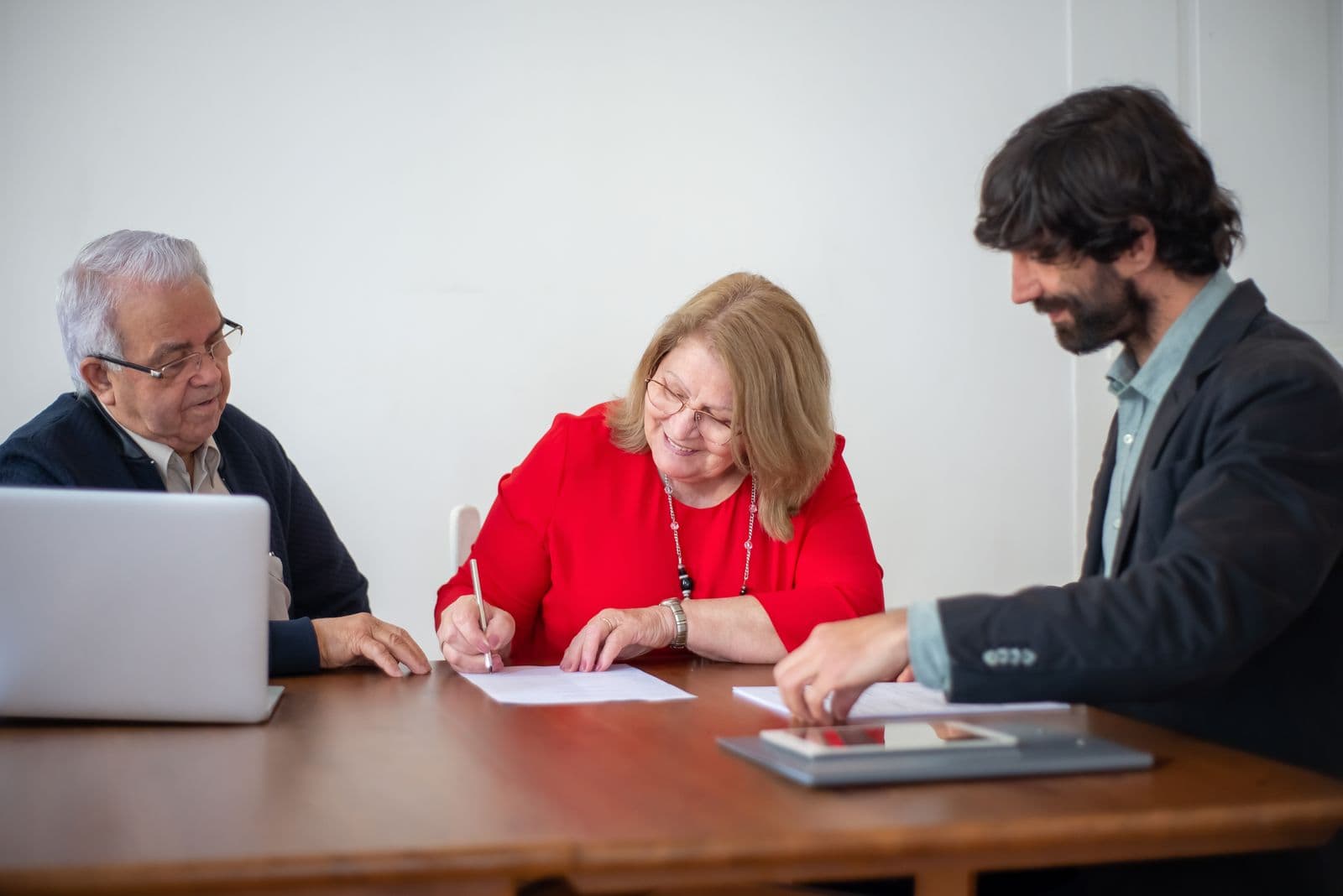 A woman signing a document in an office, confirming her authority to approve it