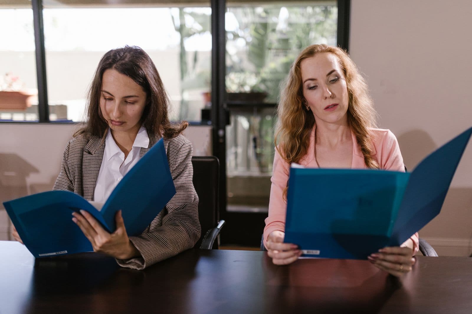 Two coworkers reviewing a document together at a desk